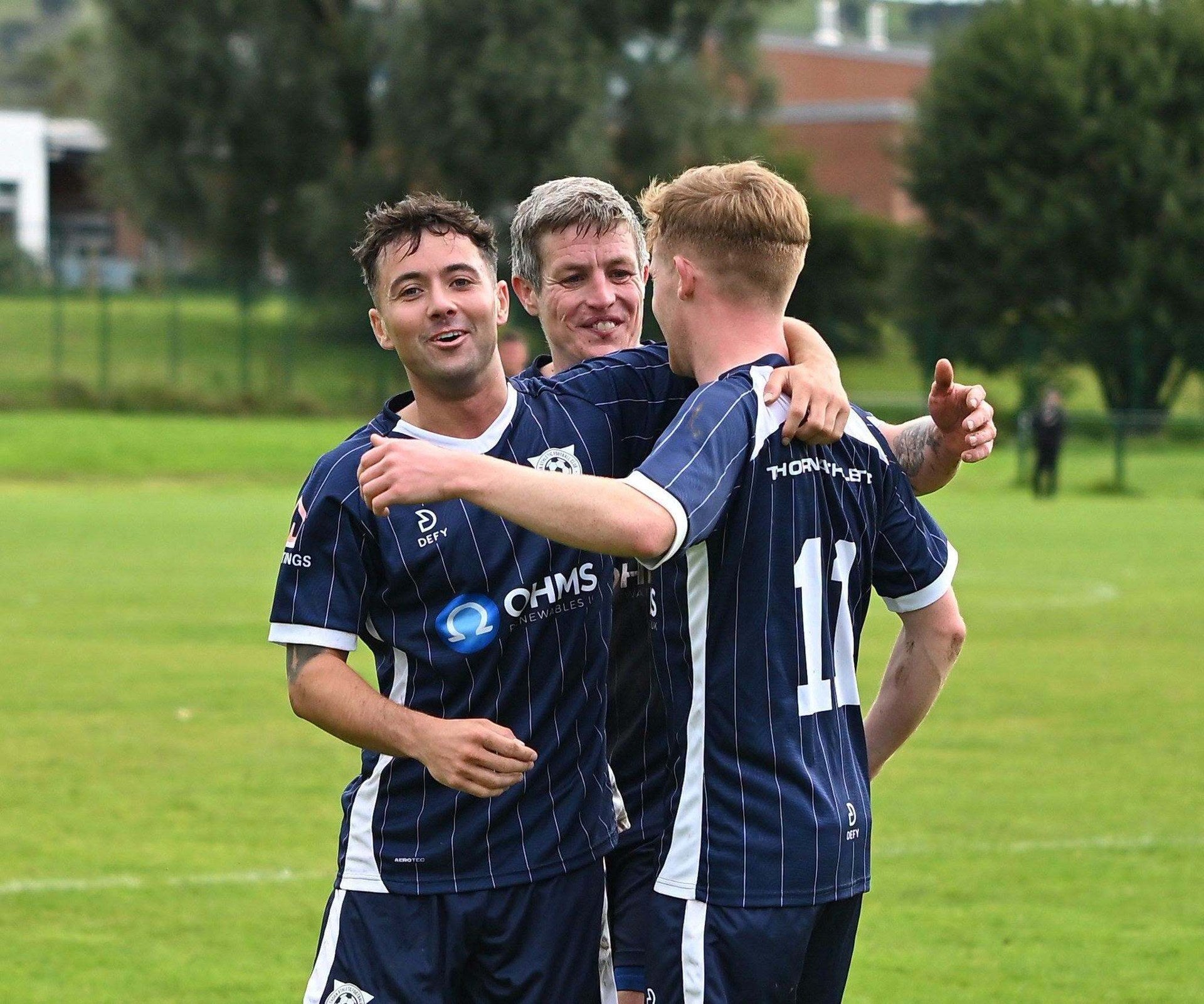 Defy football player in navy club kit